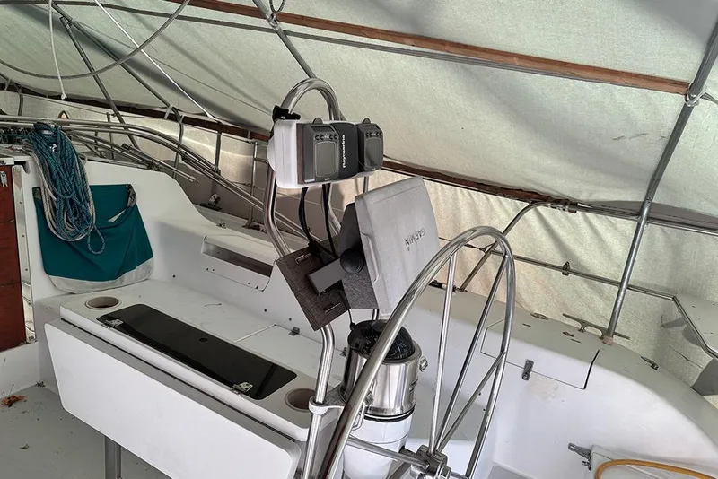Slide: The Image of 1999 Catalina 42 MkII sailboat cockpit with steering wheel and navigation equipment. - 7