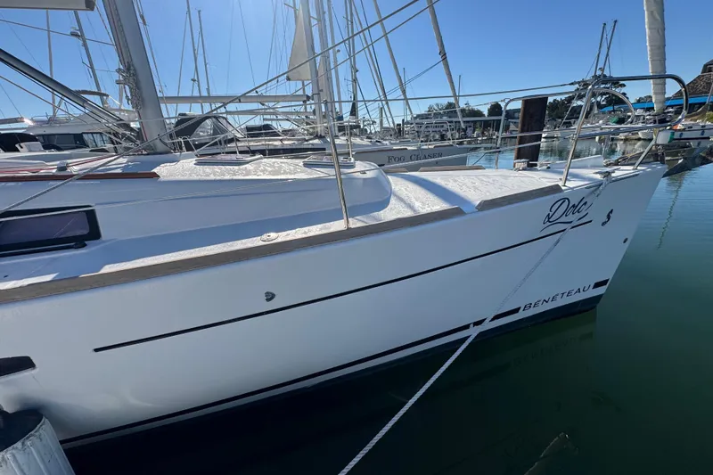 Slide: The Image of 2014 Beneteau Oceanis 34 sailboat docked in a marina under clear blue skies. - 12