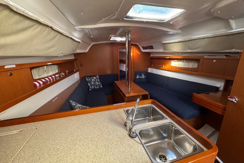 Slide: The Image of Interior of 2014 Beneteau Oceanis 34 sailboat with cozy seating and kitchenette. - 14