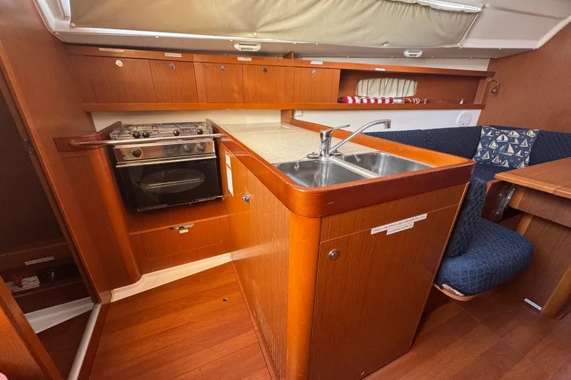 Slide: The Image of Interior of 2014 Beneteau Oceanis 34 yacht with kitchen and seating area. - 15
