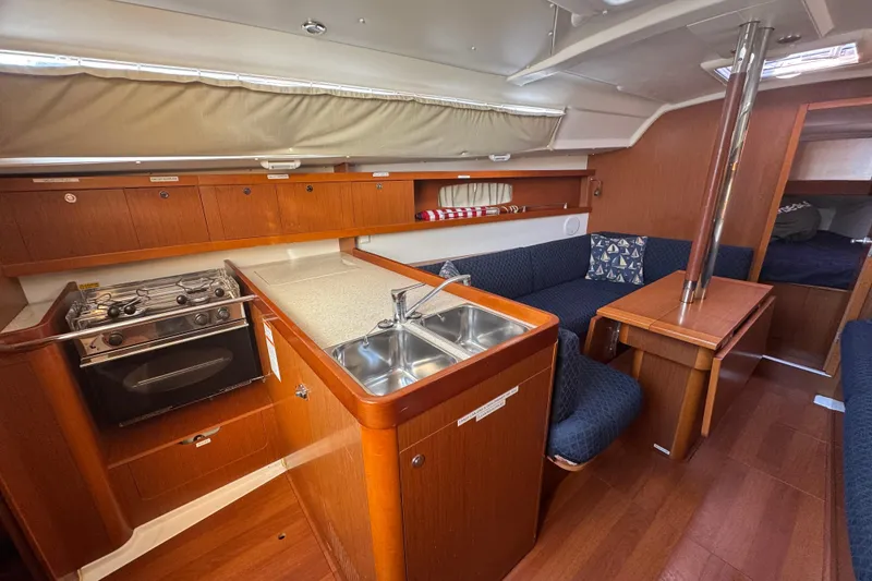 Slide: The Image of Interior of 2014 Beneteau Oceanis 34 yacht with kitchen and seating area. - 18