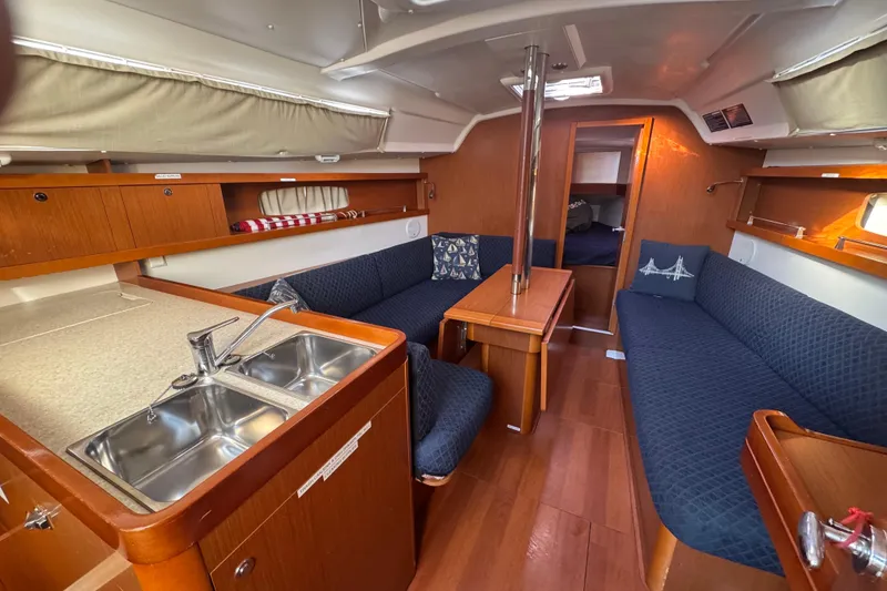 Slide: The Image of Interior of 2014 Beneteau Oceanis 34 sailboat with cozy seating and kitchenette. - 19