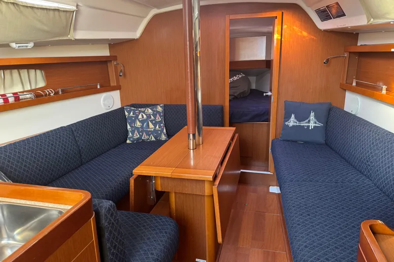 Slide: The Image of Interior of 2014 Beneteau Oceanis 34 sailboat with cozy seating and wooden finishes. - 20