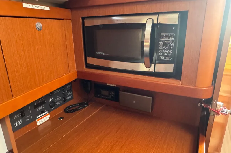 Slide: The Image of Interior of 2014 Beneteau Oceanis 34 yacht with microwave and control panel. - 24