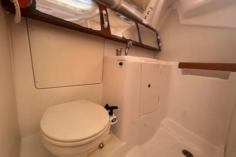 Slide: The Image of 2014 Beneteau Oceanis 34 bathroom with toilet, sink, and mirror. - 30