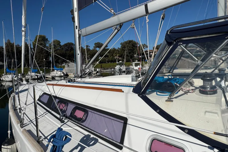 Slide: The Image of 2014 Beneteau Oceanis 34 sailboat docked, showcasing deck and rigging details. - 4