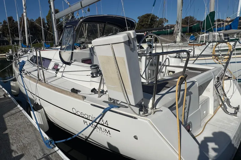 Slide: The Image of 2014 Beneteau Oceanis 34 sailboat docked at marina, side view. - 5