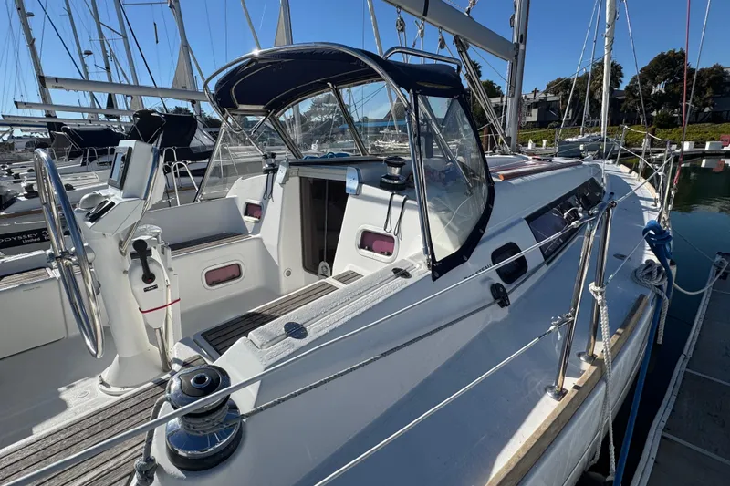 Slide: The Image of 2014 Beneteau Oceanis 34 sailboat docked, featuring a sleek cockpit and modern design. - 8