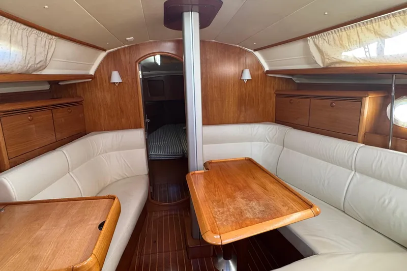 Slide: The Image of Interior of 2004 Jeanneau Sun Fast 35 sailboat with wood finish and white seating. - 15