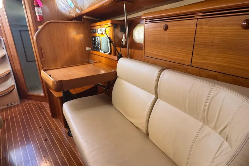 Slide: The Image of Interior of 2004 Jeanneau Sun Fast 35 sailboat with wooden cabinetry and beige seating. - 17