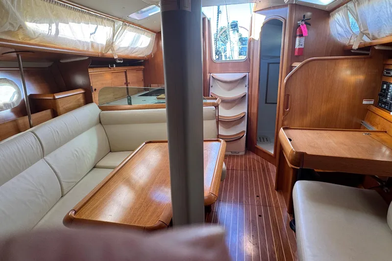 Slide: The Image of Interior of 2004 Jeanneau Sun Fast 35 sailboat with wood finish and seating area. - 18