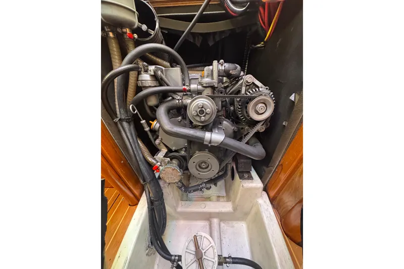 Slide: The Image of Engine compartment of a 2004 Jeanneau Sun Fast 35 sailboat, showing detailed mechanical components. - 24