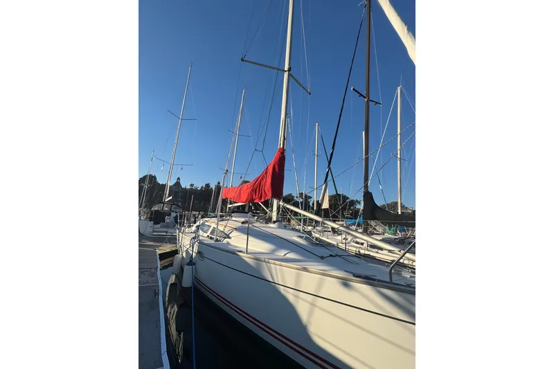 Slide: The Image of 2004 Jeanneau Sun Fast 35 sailboat docked with red sail cover. - 3