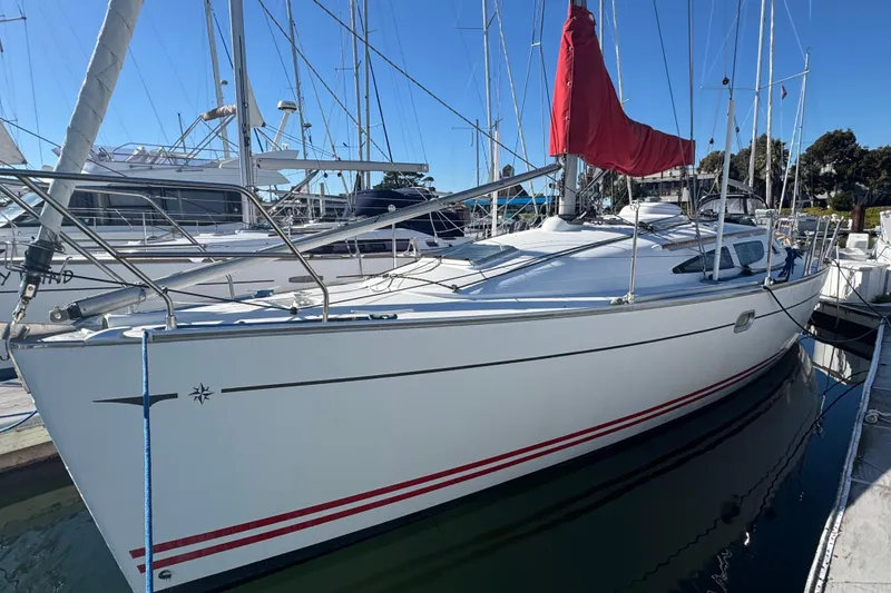 Slide: The Image of 2004 Jeanneau Sun Fast 35 sailboat docked with red sail cover. - 4
