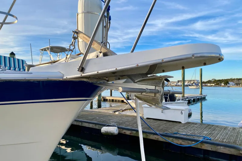 Slide: The Image of 1971 Hatteras 43 Double Cabin yacht docked at marina, sunset reflection on water. - 10