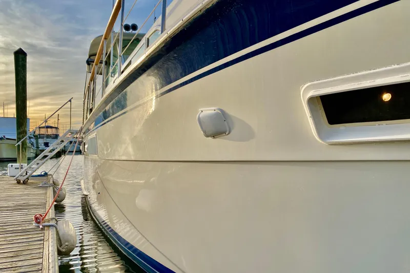 Slide: The Image of 1971 Hatteras 43 Double Cabin yacht side view with sleek design and railing. - 13