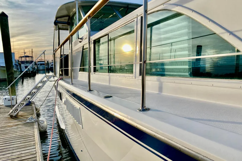 Slide: The Image of 1971 Hatteras 43 Double Cabin yacht docked with inflatable boat attached. - 14