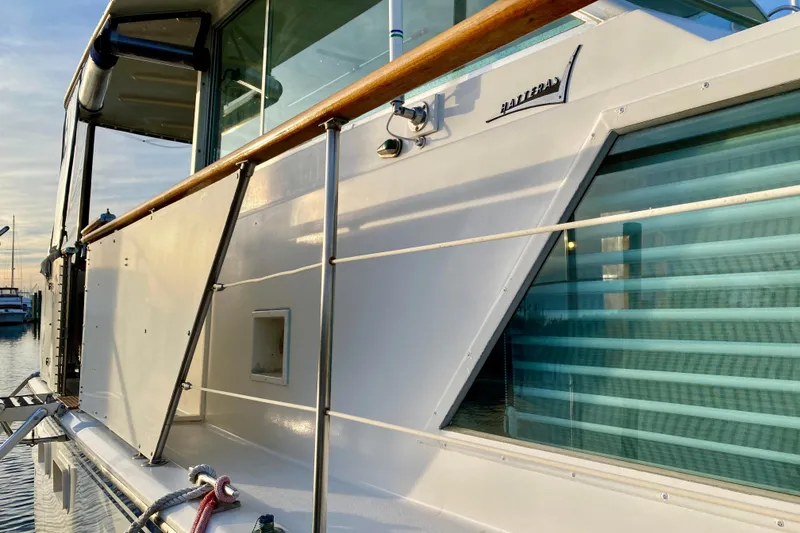 Slide: The Image of 1971 Hatteras 43 Double Cabin boat with "Lazy Livin'" name, docked with inflatable dinghy. - 15