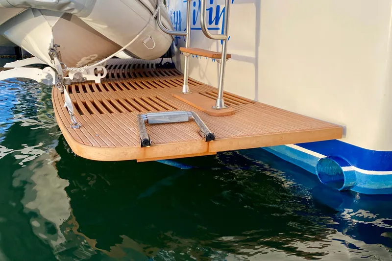 Slide: The Image of 1971 Hatteras 43 Double Cabin logo on white boat surface. - 19