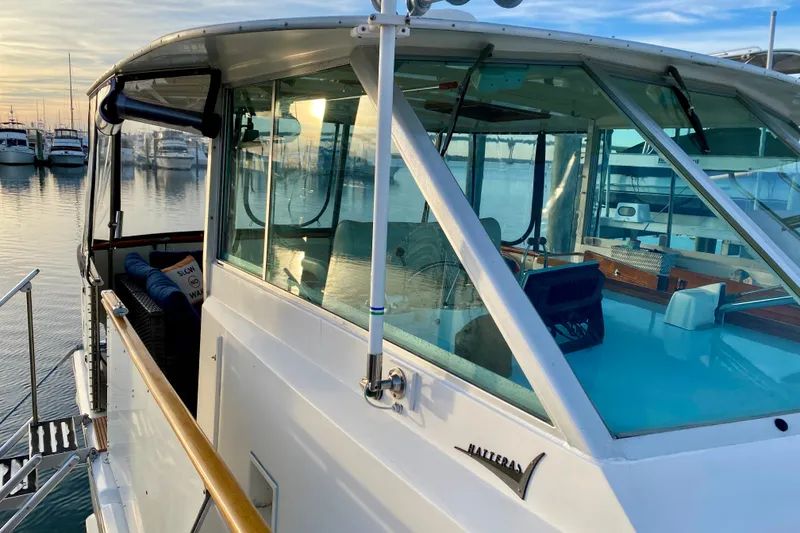 Slide: The Image of 1971 Hatteras 43 Double Cabin yacht deck with striped seating and storage. - 22