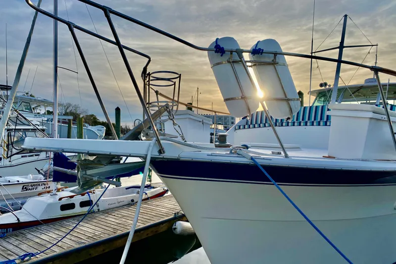 Slide: The Image of 1971 Hatteras 43 Double Cabin yacht docked at sunset, side view. - 3