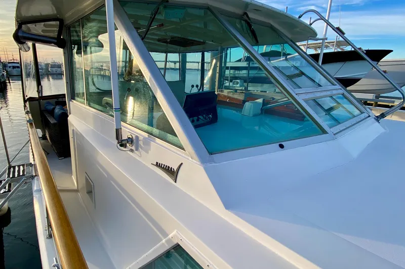 Slide: The Image of Cozy seating area on 1971 Hatteras 43 Double Cabin yacht with marina view. - 32