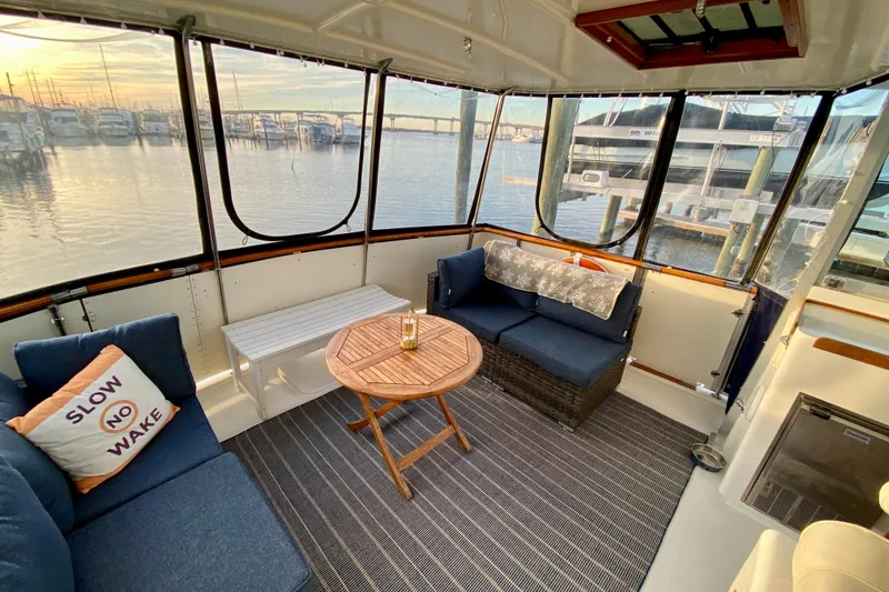 Slide: The Image of 1971 Hatteras 43 Double Cabin interior with marina view at sunset. - 33