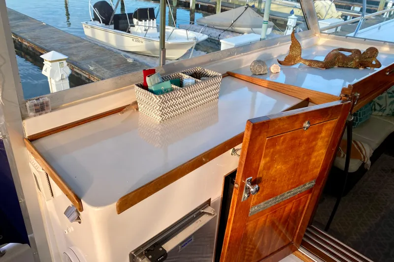 Slide: The Image of 1971 Hatteras 43 Double Cabin helm with Garmin navigation and classic controls. - 36