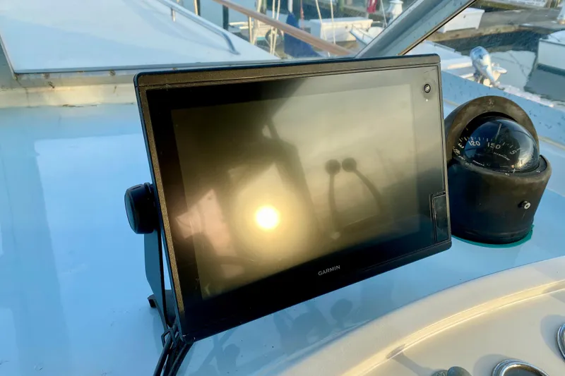 Slide: The Image of Throttle controls on a 1971 Hatteras 43 Double Cabin boat, docked by the water. - 39