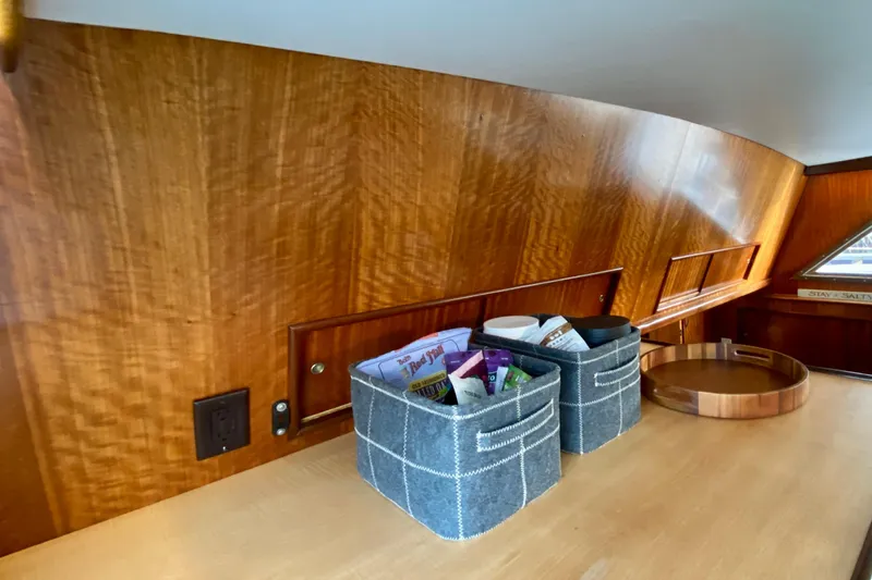 Slide: The Image of 1971 Hatteras 43 Double Cabin interior with leather chair, artwork, and bookshelf. - 49