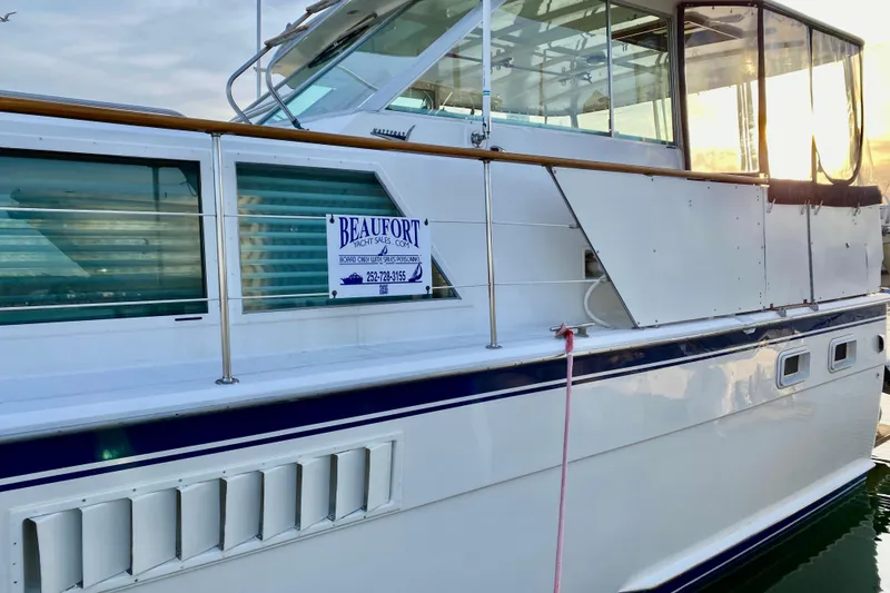 Slide: The Image of 1971 Hatteras 43 Double Cabin yacht docked, showcasing side view and windows. - 5