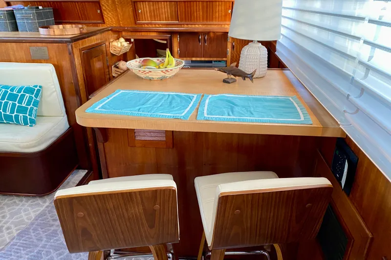 Slide: The Image of 1971 Hatteras 43 Double Cabin kitchen with wood cabinetry and marble countertops. - 50
