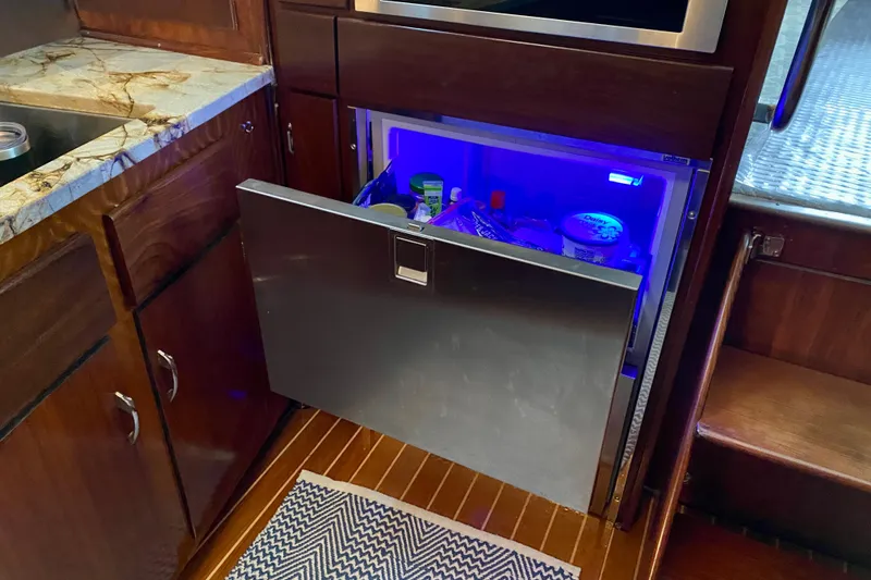 Slide: The Image of 1971 Hatteras 43 Double Cabin interior with wood paneling and modern kitchen features. - 56