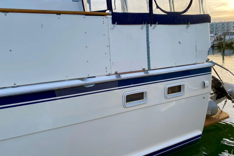 Slide: The Image of 1971 Hatteras 43 Double Cabin yacht side view with blue trim and windows. - 6