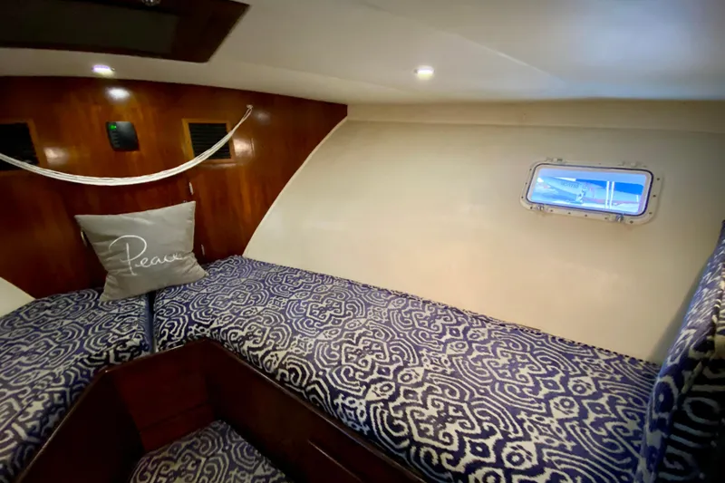 Slide: The Image of Wooden cabinet with glass containers and mugs inside a 1971 Hatteras 43 Double Cabin. - 67