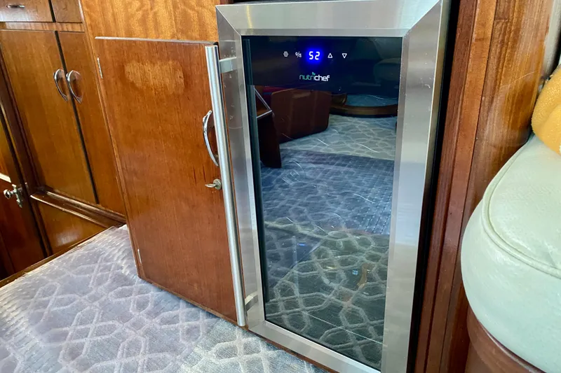 Slide: The Image of 1971 Hatteras 43 Double Cabin interior with wooden cabinet and glassware display. - 71