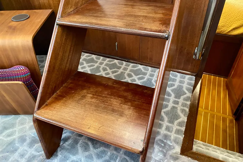 Slide: The Image of 1971 Hatteras 43 Double Cabin interior with twin beds, wooden cabinetry, and nautical decor. - 75