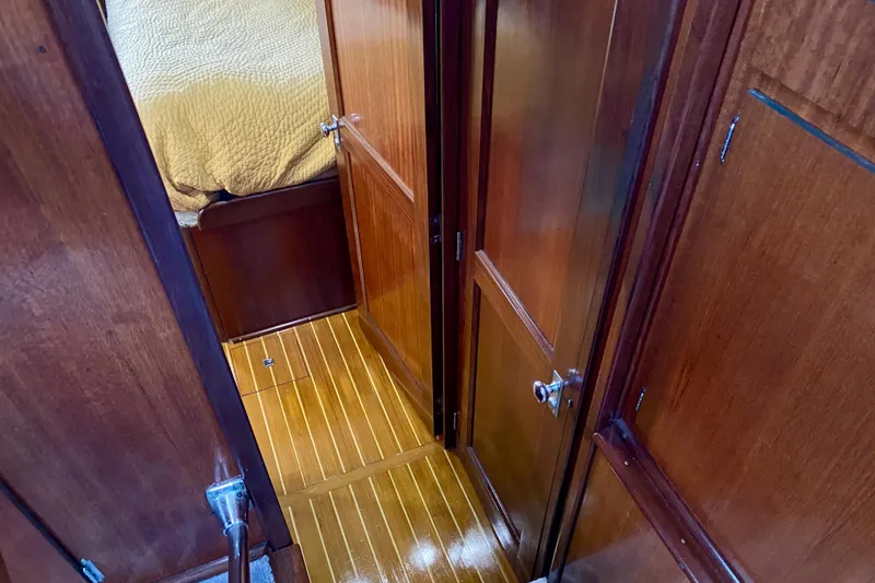 Slide: The Image of 1971 Hatteras 43 Double Cabin interior with cozy bed and wooden paneling. - 76