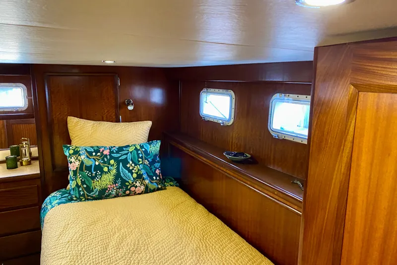 Slide: The Image of Interior of 1971 Hatteras 43 Double Cabin with colorful rug and leather ottoman. - 78