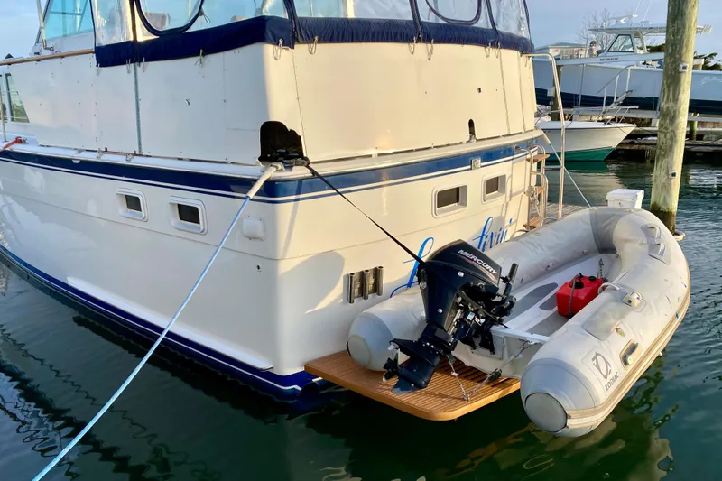 Slide: The Image of 1971 Hatteras 43 Double Cabin yacht docked with inflatable boat attached. - 8