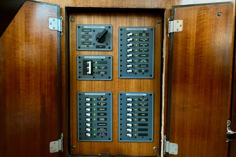 Slide: The Image of Electrical panel of a 1971 Hatteras 43 Double Cabin boat, featuring AC and DC distribution. - 93