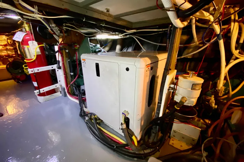 Slide: The Image of Engine room of a 1971 Hatteras 43 Double Cabin with visible machinery and equipment. - 97