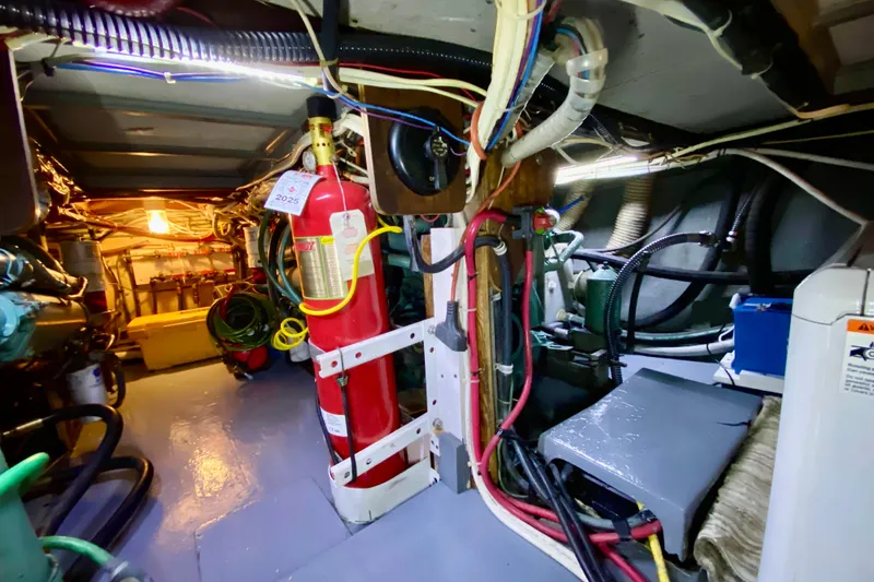 Slide: The Image of Battery setup in a 1971 Hatteras 43 Double Cabin boat, featuring lithium batteries and wiring. - 98