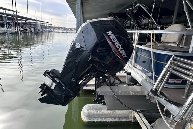 Slide: The Image of 2024 Sun Tracker Bass Buggy 18 DLX with Mercury outboard motor at dock. - 5