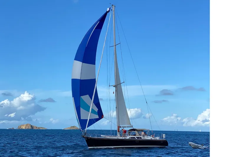 The Image of 1998 Hylas 54' sailboat on open sea with blue sky. - 1