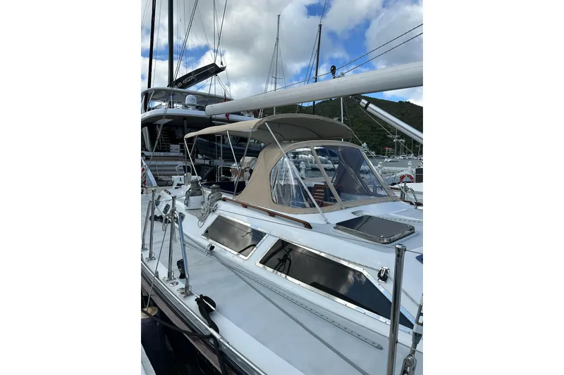 Slide: The Image of 1998 Hylas 54' yacht with sleek design, docked under a cloudy sky. - 10