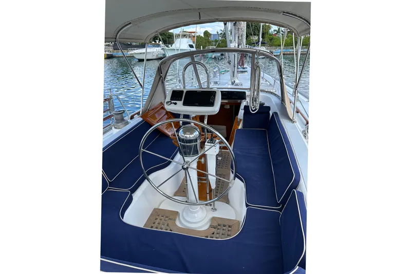 Slide: The Image of Cockpit of a 1998 Hylas 54' yacht with blue seating and steering wheel. - 11