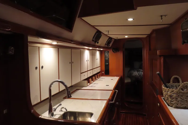 Slide: The Image of Luxurious interior of a 1998 Hylas 54' yacht with elegant wood cabinetry and modern fixtures. - 24