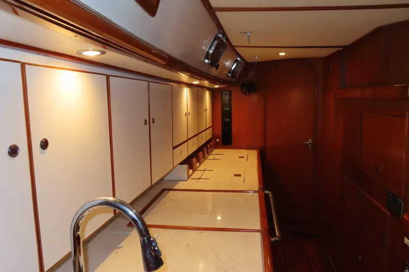 Slide: The Image of Luxurious interior of a 1998 Hylas 54' yacht with wooden cabinetry and modern fixtures. - 25