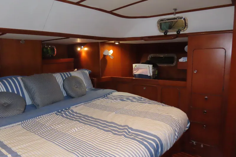 Slide: The Image of Luxurious cabin interior of a 1998 Hylas 54' yacht with striped bedding. - 27
